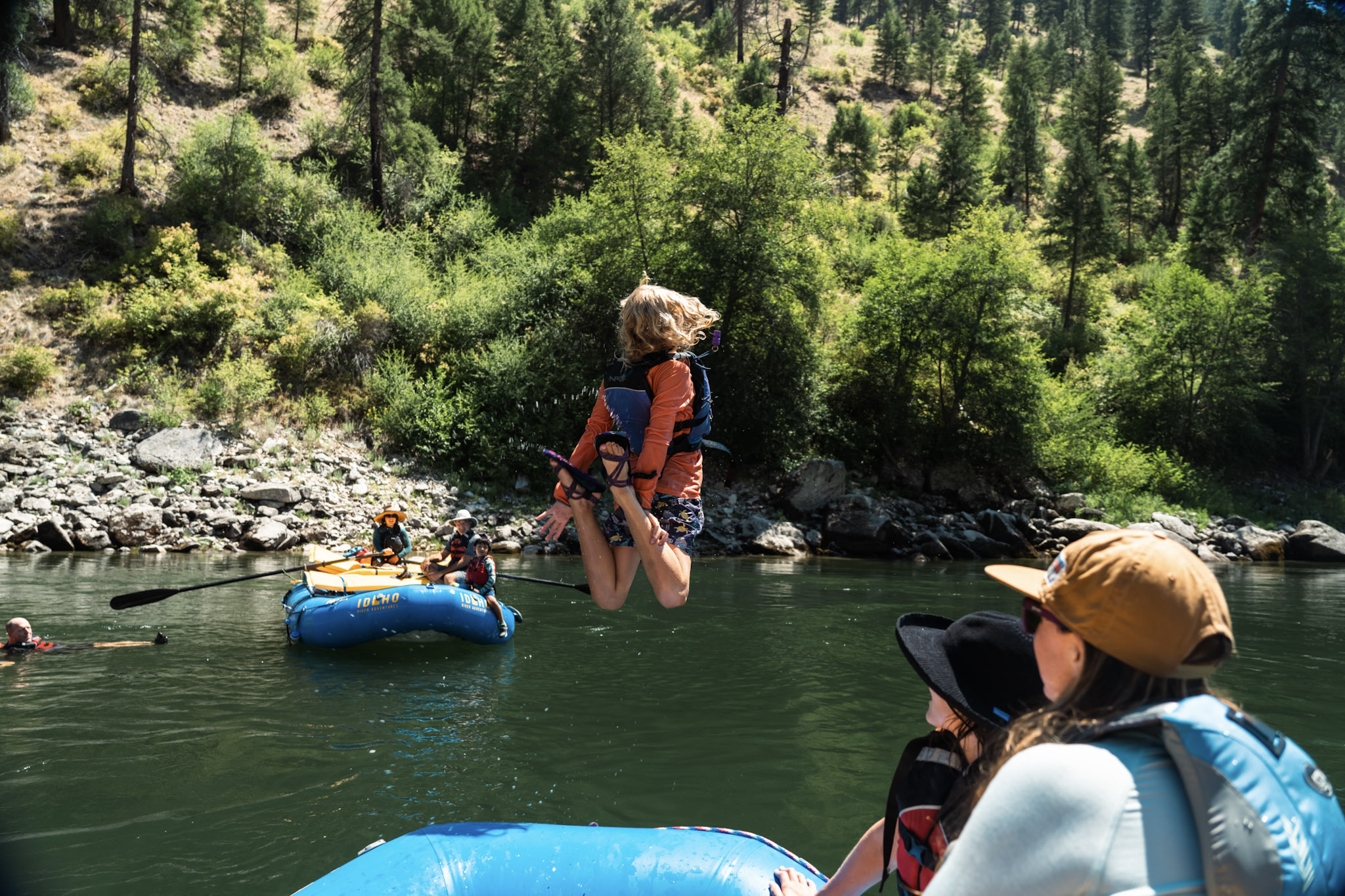 kid having fun jumping into the main salmon river off of a raft