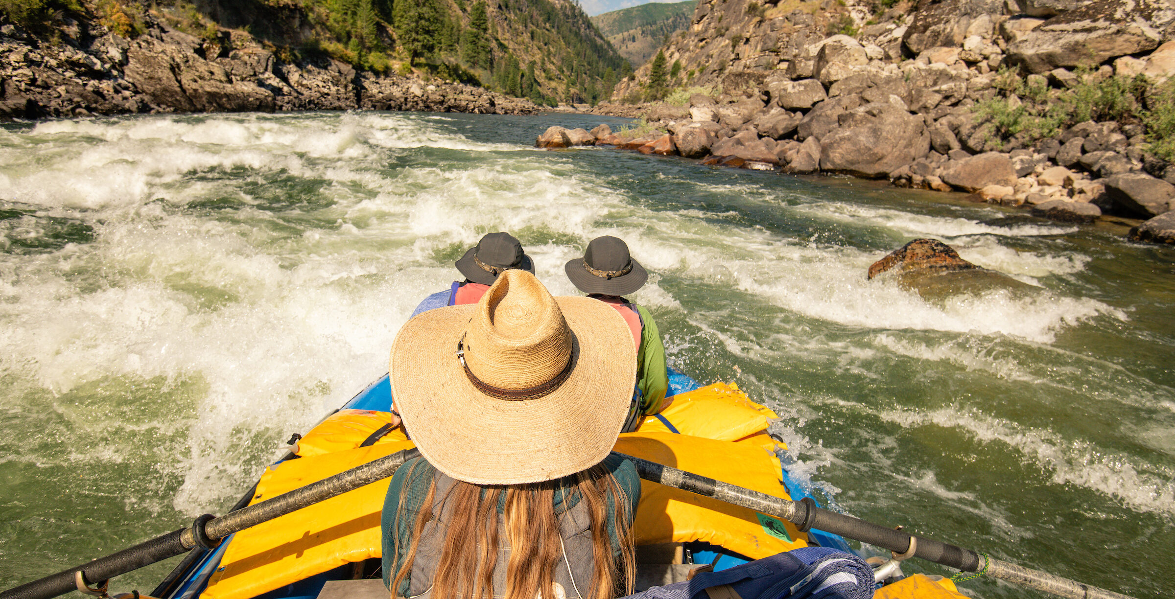 raft with people going down a rapid on the main salmon river